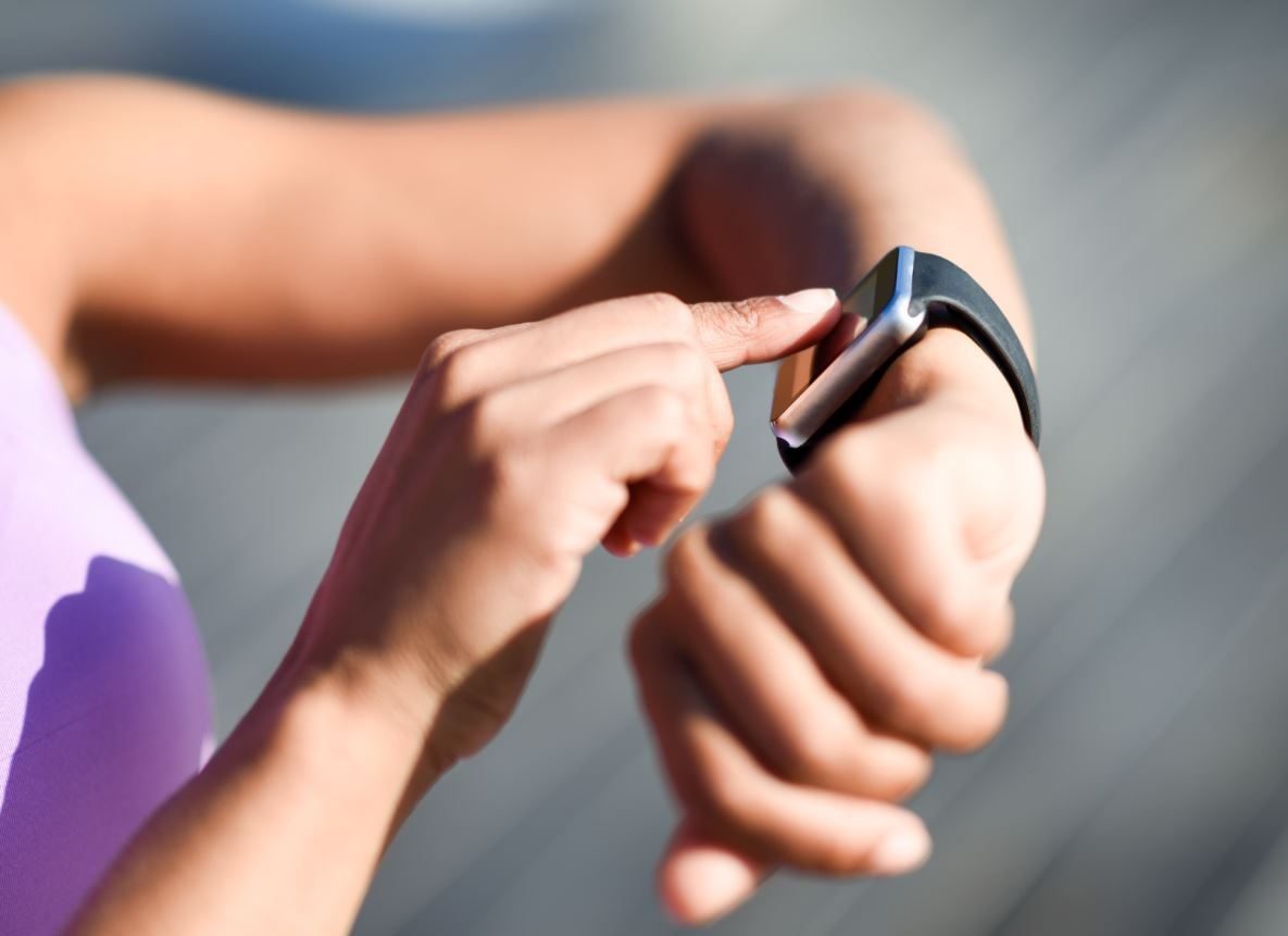 woman using smartwatch touching touchscreen V4CM7H6