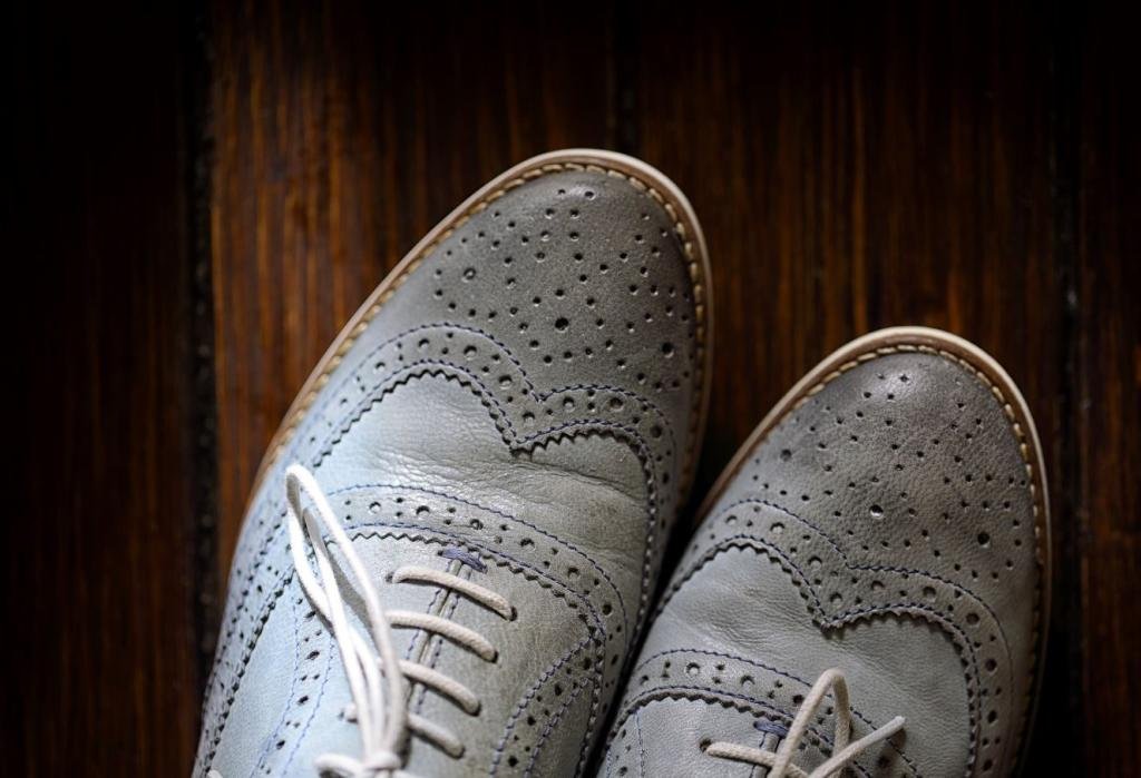 grey oxford shoes on wooden background P4CHK4N