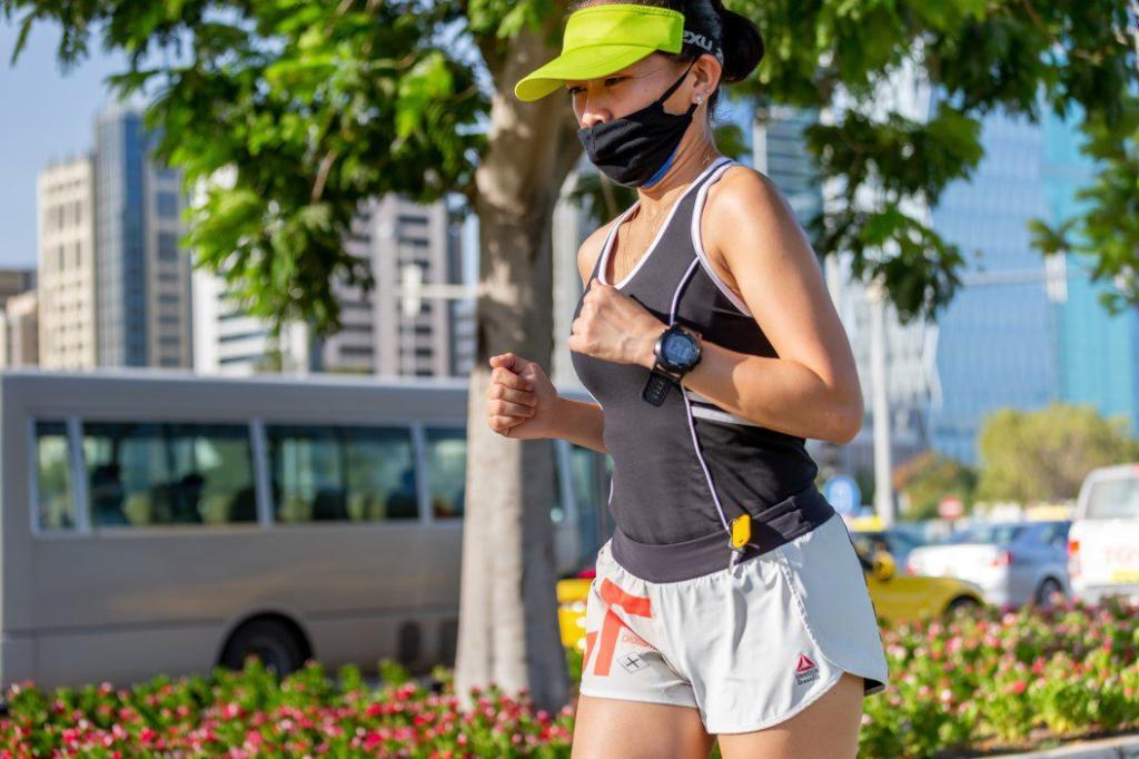 woman running on the street wearing protection mask t20 YEVBLR