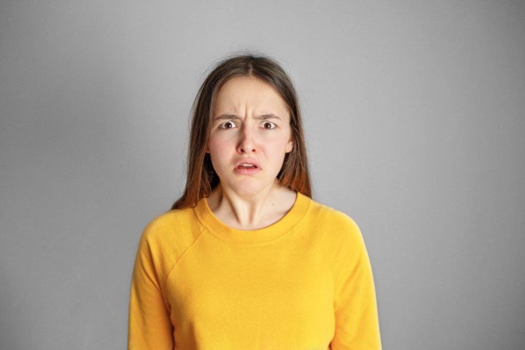 high school drama portrait of young teenager girl with disgusted upset angry face expression at grey background looking t20 ynmzr6