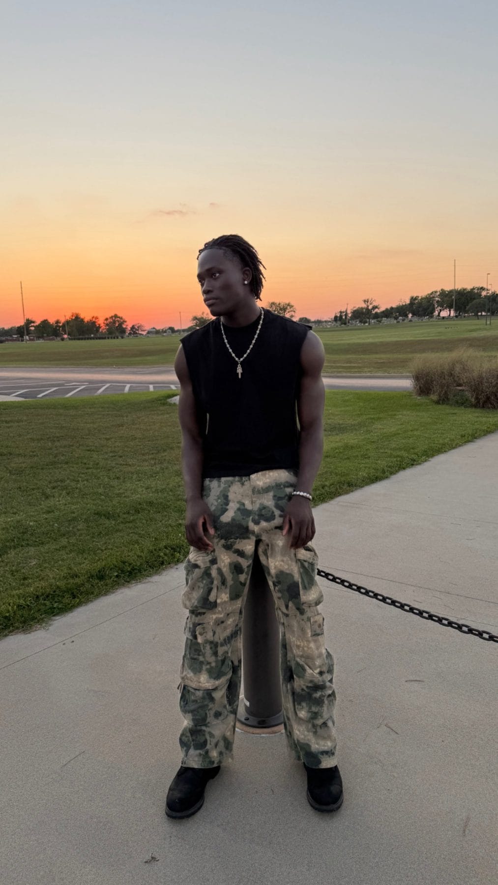 Darkson posing outdoors at sunset