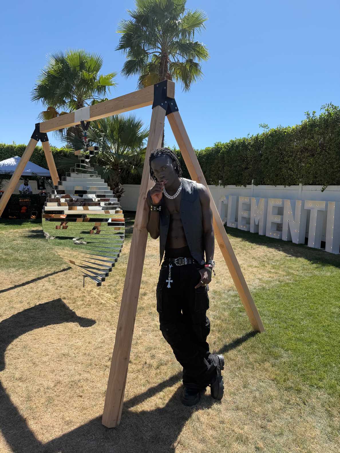 Darkson posing at an outdoor fashion event