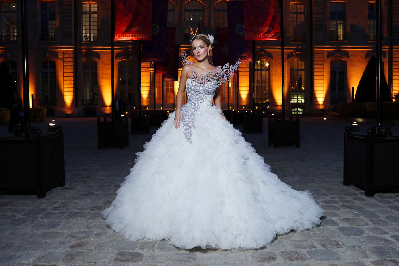 Mckenna Grace wears a voluminous white gown in the Musée Rodin courtyard